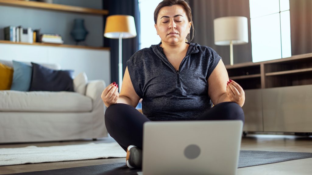 Woman engaging in online somatic therapy for ADHD in the comfort of her own home.