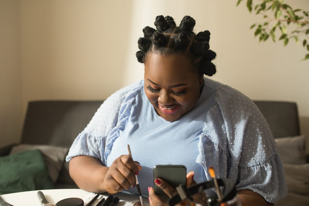 Black female engaging in a relational therapy approach while doing art in session