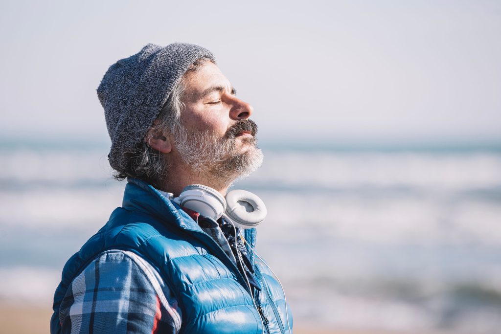 A man on the beach. relaxing deep breathing. 