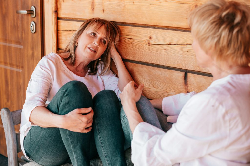Female friend supporting her friend who is hard on herself. 